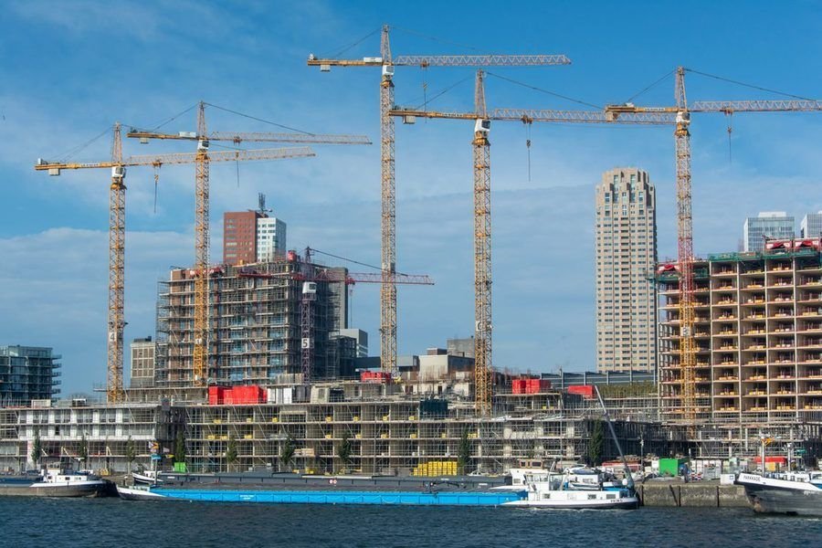 Large construction site with multiple tower cranes